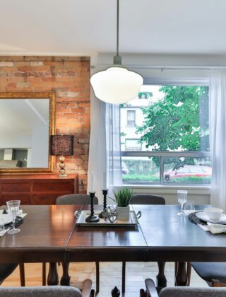 Hanglamp laag boven een houten eettafel met stoelen